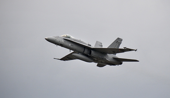 A Finnish F/A-18 Hornet in the air, the sky is cloudy