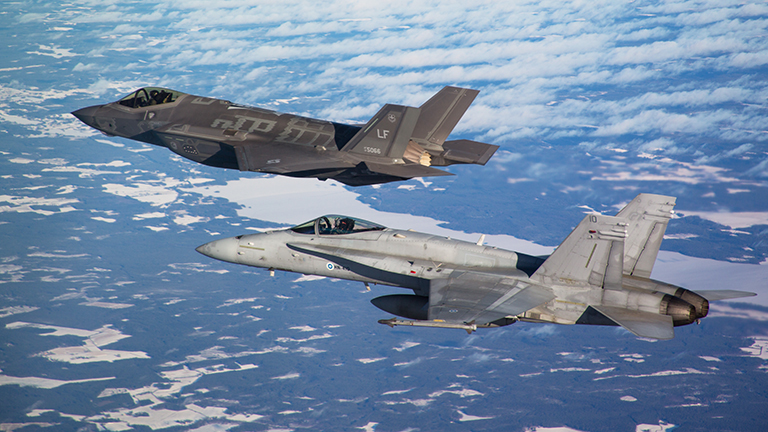 Lockheed Martin F-35A Lightning II and Hornet multi-role fighters flying