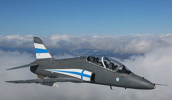 Hawk-suihkuharjoituskone lähikuvassa lentämässä pilvien yllä.