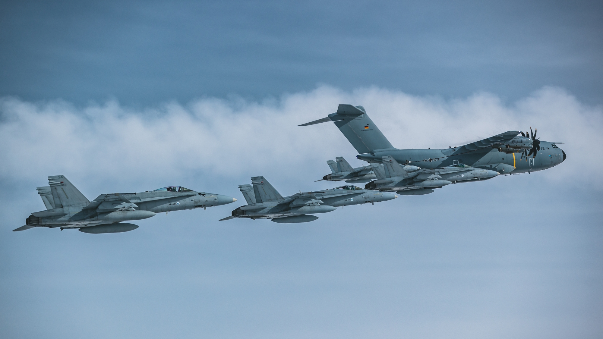 Four Finnish F/A-18 Hornets and a German A400M