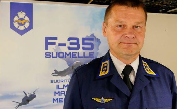 Commander of the Finnish Air Force in front of a F-35 Programme roll-up