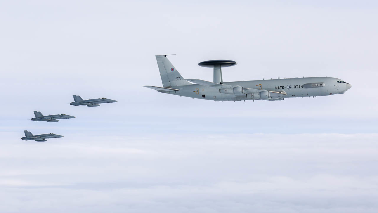 Finnish Air Force F/A-18s and a NATO E-3A Sentry AWACS.